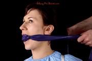 Julia tied and gagged in a shiny PVC suit