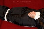 Samantha bound and gagged in shiny nylon rainwear