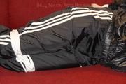 Samantha bound and gagged in shiny nylon rainwear