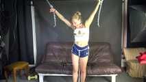Watching sexy Sandra wearing an darkblue shiny nylon shorts and a white adidas top being tied and gagged overhead with ropes, chaines and a ballgag (Video)