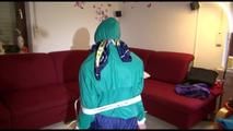 Mara tied, gagged and hooded on the back of an chair wearing a hot rain pants and a shiny nylon shorts over it and a rain jacket (Video)