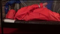 Jill tied, gagged and hooded on a princess bed wearing shiny orange rainwear (Video)