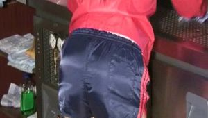 Jill Diamond woring on a bar wearing a sexy shiny nylon shorts and a rain jacket (Video)