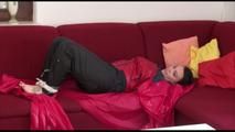 Jill tied, gagged and hooded on a sofa wearing sexy shiny black rain pants and an oldschool red/blue rain jacket (Video)