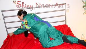 Lucy putting on linen on bed wearing supersexy green shiny nylon rainwear (Pics)