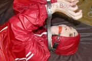 Jill tied, gagged and hooded with a pillory and cuffs wearing sexy shiny nylon rainwear (Pics)