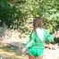 Stella wearing a supersexy green shiny nylon shorts and a green rain jacket as well as green rubber boots while jumping in puddles (Pics)