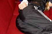 Samantha bound and gagged in shiny nylon rainwear
