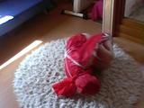 Black haired archive girl tied, gagged and hooded on the floor wearing a shiny red nylon shorts and a shiny red rain jacket (Video)