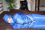 Jill tied, gagged and hooded on bed wearing a supersexy supershiny lightblue downwear (Pics)