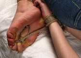 Doris hogtied on bed