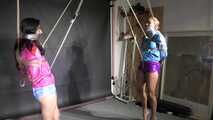 Aiyana and Ms Ungeniert in shiny nylon Shorts and Windbreaker tied and gagged together