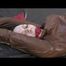 Simone tied and gagged on bed wearing a brown shiny nylon rainjacket and a rainpants (Video)