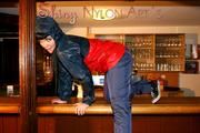 Jill posing and lolling in a bar wearing oldschool shiny nylon rainwear (Pics)