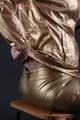 Blonde archive girl posing in a studio wearing a sexy golden rainwear combination (Pics)