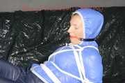 ***SEXY SANDRA*** wearing a supersexy skinny shiny nylon pants and a lightblue shiny nylon rain jacket being bound on a sofa with ropes and a ball gag (Pics)