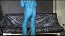Pia ties and gagges herself with cuffs wearing a sexy green shiny nylon down suit (Video)