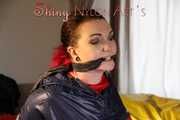 Watching sexy Jill being tied and gagged with ropes and a ballgag on a bed wearing a sexy red shiny nylon shorts and an oldschool rain jacket (Pics)