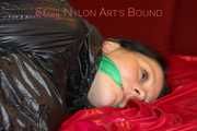 LUCY tied and gagged with ropes and a cloth gag on a sofa wearing a supersexy black shiny nylon shorts and black rain jacket (Pics)