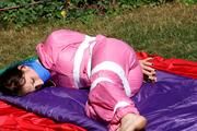 Julia tied and gagged in a shiny nylon skisuit