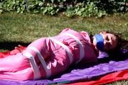 Julia tied and gagged in a shiny nylon skisuit