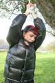 Jill tied and gagged outdoor on a tree wearing a sexy black downjacket and a black rain pants (Pics)