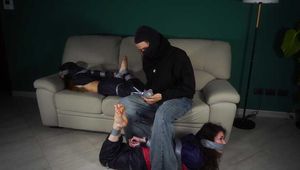 Rey Sanson and Fatima bound and gagged with Tape by an Intruder wearing Rainwear. Poor guys. They had differebt plabs for the evening but end up both tied and gagged tightly, struggeling to get free.