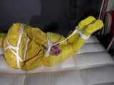 Watch Pia enjoying Bondage in her shiny nylon yellow Rainwear