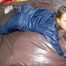 Stella wearing a supersexy blue shiny nylon rainwear while lolling in bed (Pics)