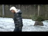 Blonde-haired archive girl going out wearing shiny nylon rainwear (Video)