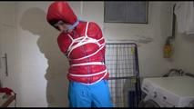 Mara tied, gagged and hooded in a laundry wearing a sexy blue down pants and a red down jacket (Video)
