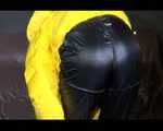 Sexy Mara trying on her new yellow down jacket and her lifevest in combination with a sexy shiny black rain pants and rubber boots (Video)