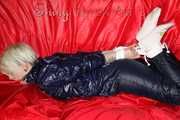 Sexy Courtney being tied and gagged with ropes and a ballgag on a bed wearing dark blue rainwear (Pics)