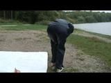 Enni wearing shiny nylon shorts and a rain jacket as well as a rain pants over the shorts (Video)