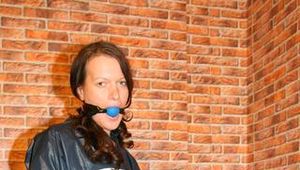 Beautiful archive girl tied and gagged on a chair wearing shiny rainwear (Pics)