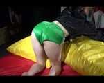 Sexy Sonja wearing a green shiny nylon shorts and a black rain jacket lolling in shiny nylon linen (Video)