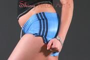 Beautiful archive girl posing in a photostudio wearing a supersexy shiny nylon shorts and a top (Pics)