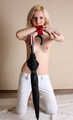 Topless barefoot Hannah, bound with her hands tied up in front of her, poses with umbrella