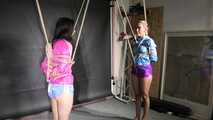 Aiyana and Ms Ungeniert in shiny nylon Shorts and Windbreaker tied and gagged together