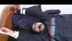 0230 min video with Jill tied and gagged in rainware in bed