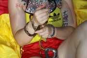 SEXY MARA ties and gagges herself with cuffs and a ball gag wearing a sexy red/yellow shiny nylon shorts and a sexy yellow top (Pics)