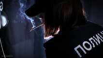 Police woman is smoking 3 strong reds in the studio