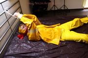 Pia tied and gagged in a shiny nylon rainsuit 