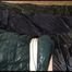 Pia tied, gagged and hooded lying on a bed with shiny nylon cloth wearing a sexy black adidas nylon pants and a green down jacket(Video)