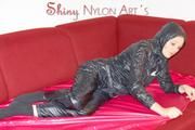 Lucy wearing a very hot black rainwear combination lolling and posing on a sofa (Pics)