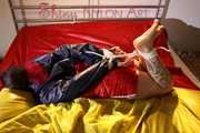 Watching sexy Jill being tied and gagged with ropes and a ballgag on a bed wearing a sexy red shiny nylon shorts and an oldschool rain jacket (Pics)