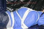 ***SEXY SANDRA*** wearing a supersexy skinny shiny nylon pants and a lightblue shiny nylon rain jacket being bound on a sofa with ropes and a ball gag (Pics)