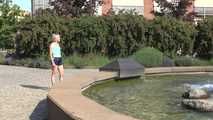 Watching SEXY SONJA walking through the city wearimg a blue shiny nylon shorts and tshirt (Video)