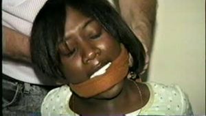 BLACK BANK TELLER IS MOUTH STUFFED, CLEAVE GAGGED & ROPE TIED TO CHAIR  (D46-2)