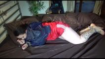 Jill tied and gagged by Sophie with cuffs and chains wearing a sexy shiny nylon shorts and a rain jacket (Video)